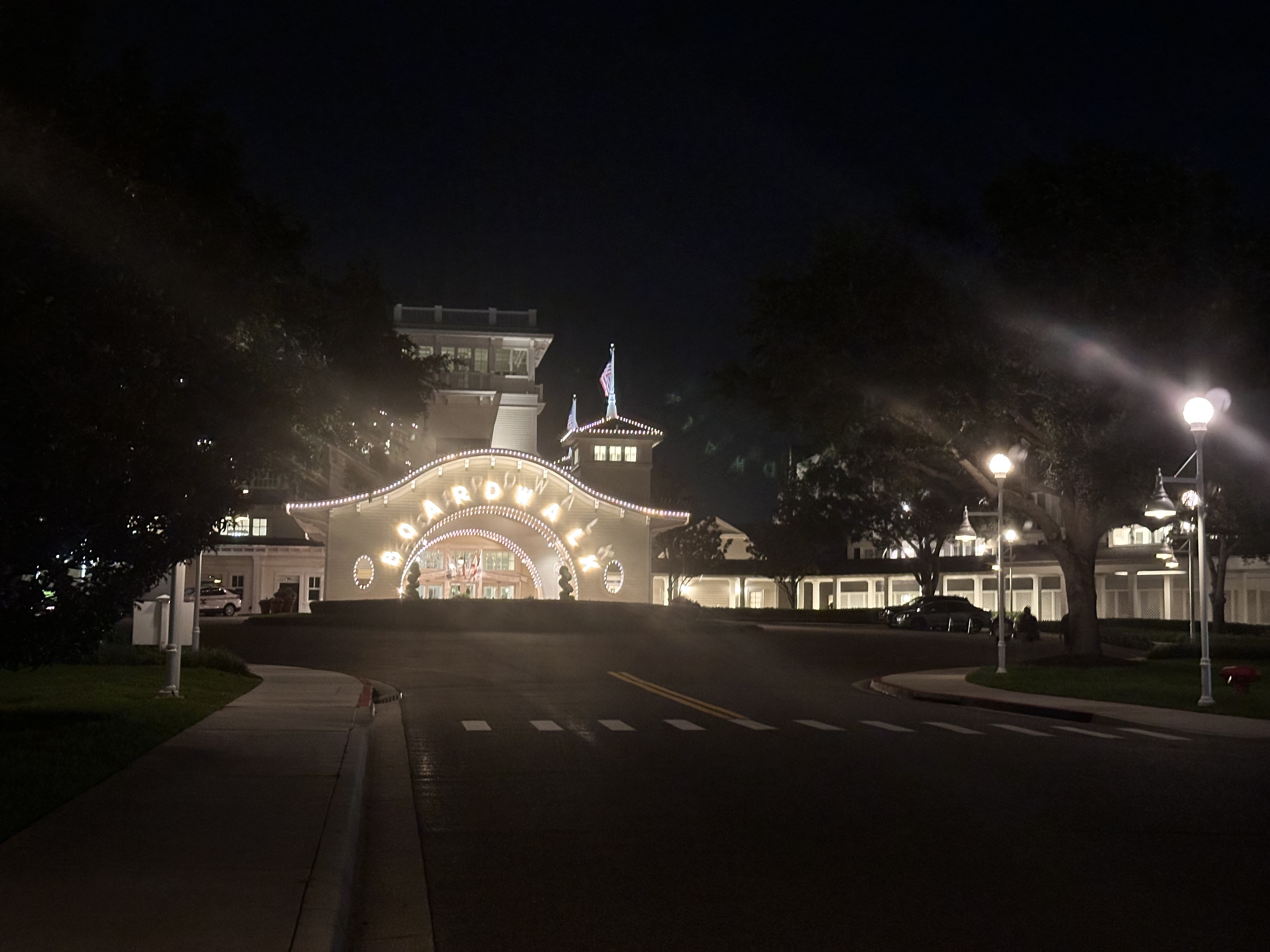Arched entryway to Boardwalk hotel at night with lights